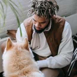 man petting a dog 