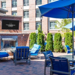 outdoor fireplace with tables and chairs